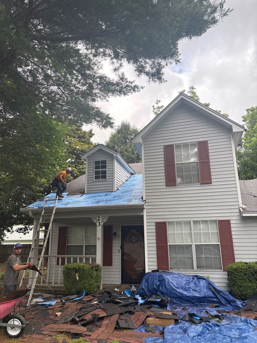 Emergency roof tarp installed to protect a home after storm damage.