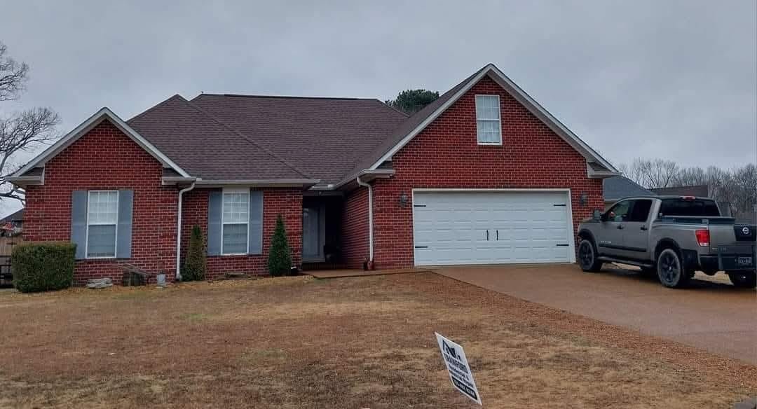 Two-story home with completed roof replacement by Crawford in Jackson, TN.